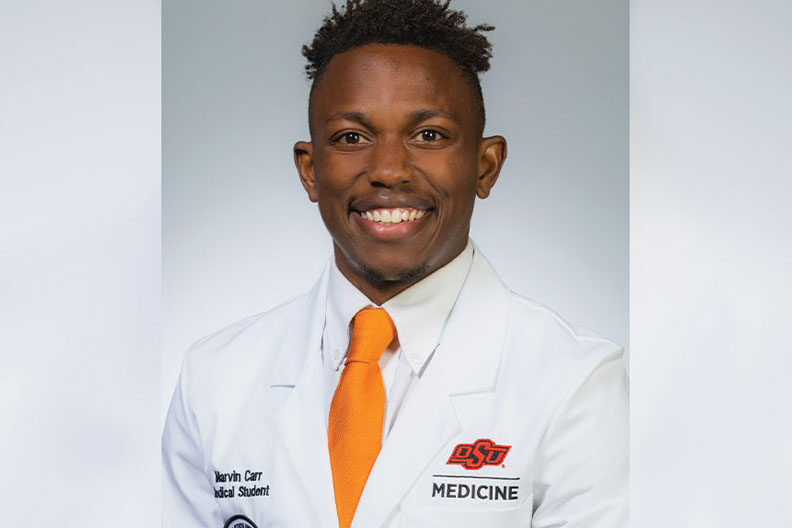 Elmhurst University alumnus Marvin Carr is pictured in his Oklahoma State University white coat.