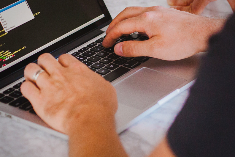 student typing about undergraduate and graduate studies