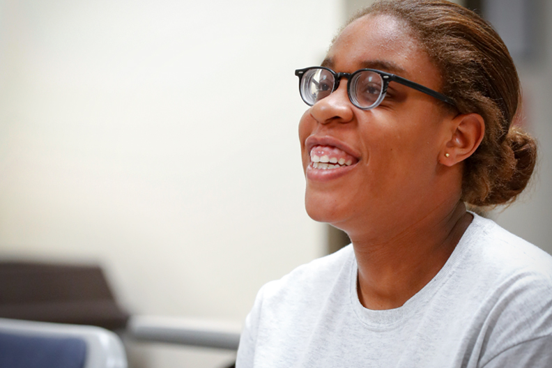 student smiling about undergraduate and graduate studies