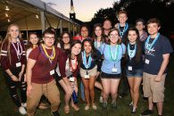 A group of students pose together for a photo on the Elmhurst University campus.