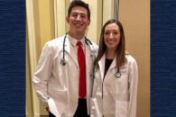 A photo of Elmhurst College students Dian Ivanov and Kristen Hulbert, who received their white coats at Rush Medical College.