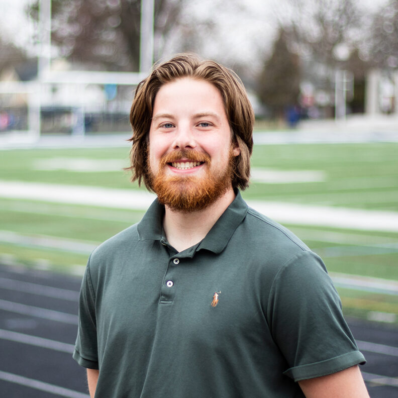 Smiling man on track field
